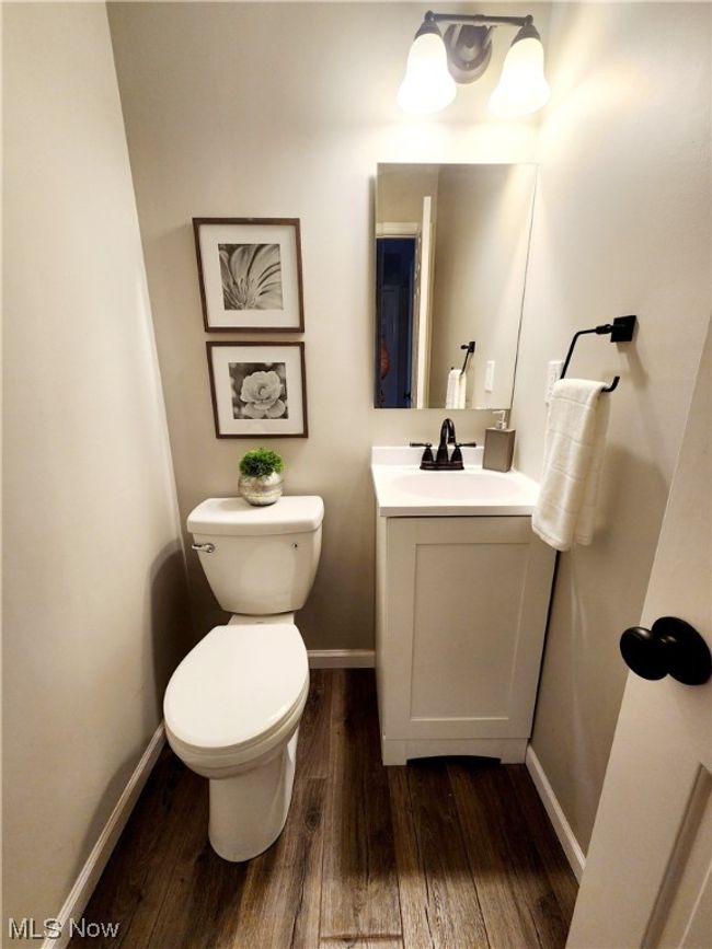 Bathroom featuring toilet, vanity, and wood-type flooring | Image 9