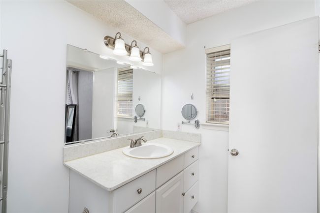 Bathroom featuring vanity, a wealth of natural light, and a textured ceiling | Image 21