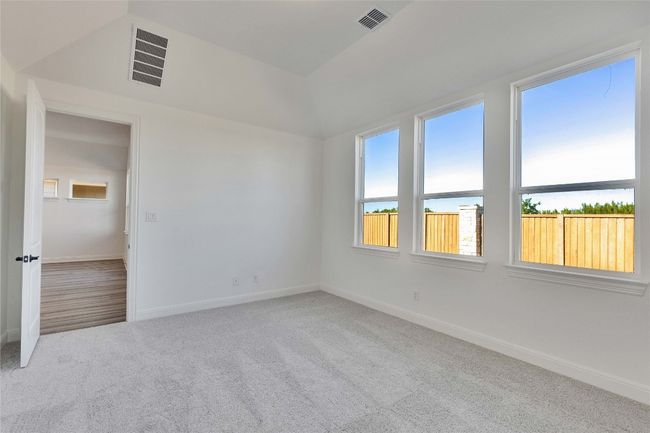Carpeted empty room with baseboards and visible vents | Image 5