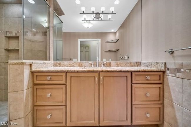 Bathroom with tile walls, a shower, and vanity | Image 25