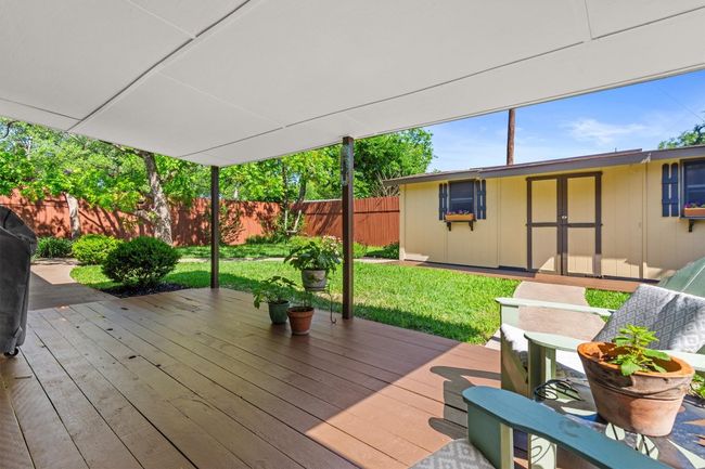 The covered deck offers a shaded space for outdoor dining, relaxing, or entertaining, no matter the weather. | Image 26
