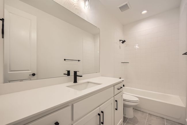 Full bath with vanity, toilet, recessed lighting, shower / tub combination, and tile patterned flooring | Image 25