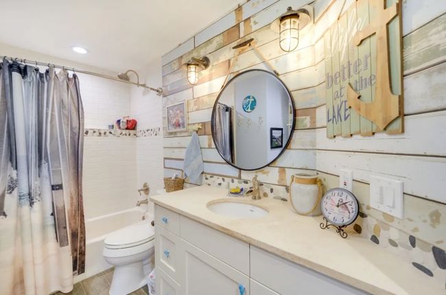 Bathroom with vanity, shower / bathtub combination with curtain, and recessed lighting | Image 16