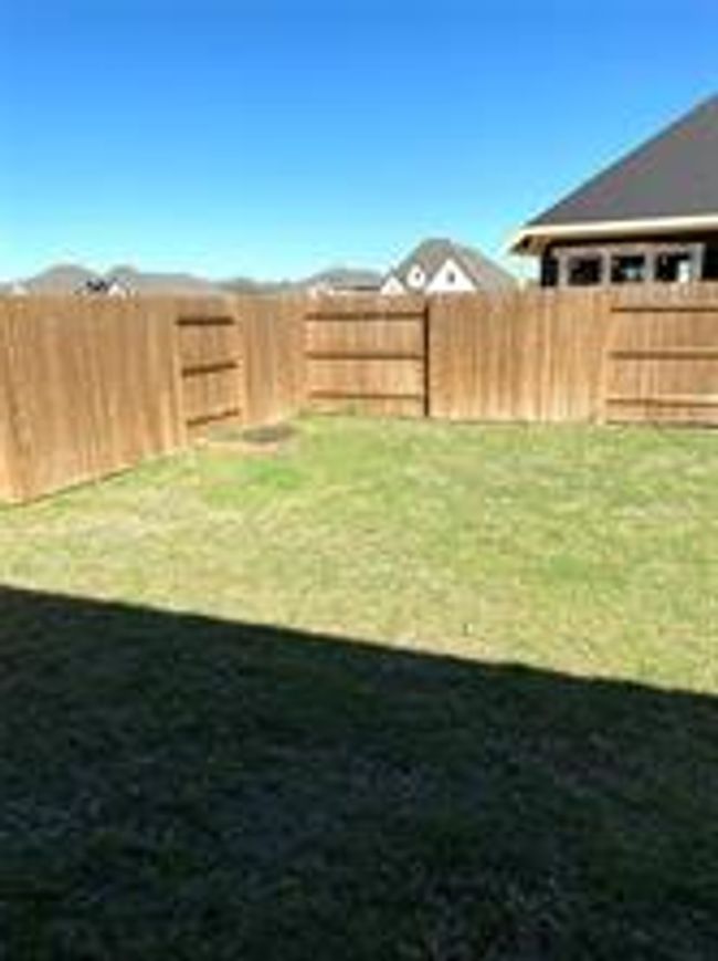 View of fenced backyard | Image 23
