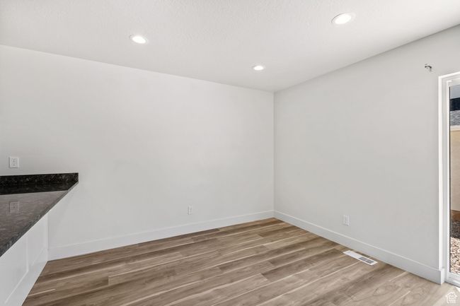 Unfurnished dining area with Luxury Vinyl plank flooring, baseboards, and recessed lighting | Image 20
