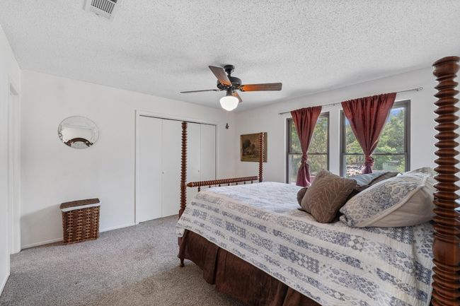 Tucked upstairs at the back of the home, the primary bedroom offers a peaceful escape with treetop views and just the right amount of quiet | Image 15