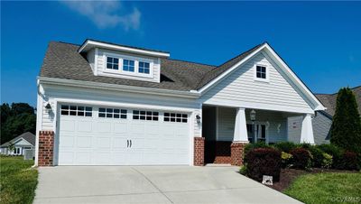 View of front of home featuring a garage and covered porch | Image 1