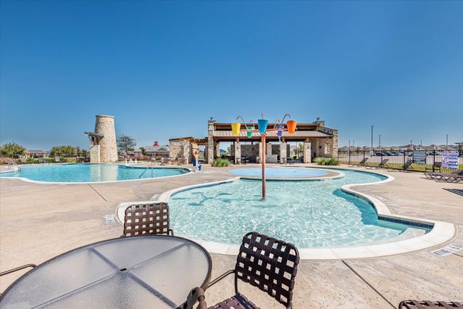 Community pool with fence and a patio | Image 37