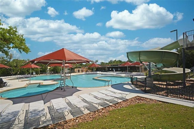 Pool with a patio, a water slide, and fence | Image 38