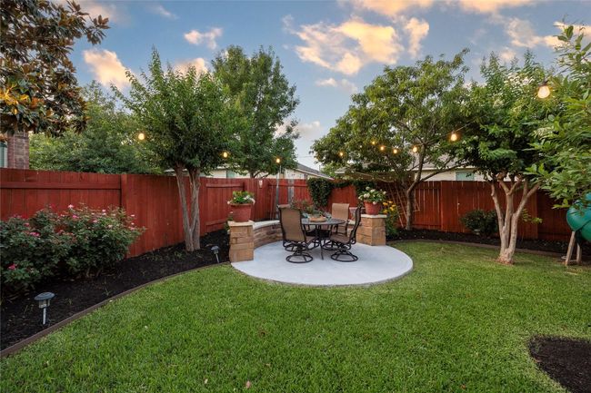 Fenced backyard with a patio | Image 23