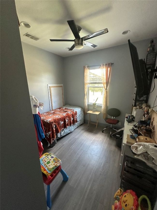 Bedroom featuring wood finished floors and ceiling fan | Image 39