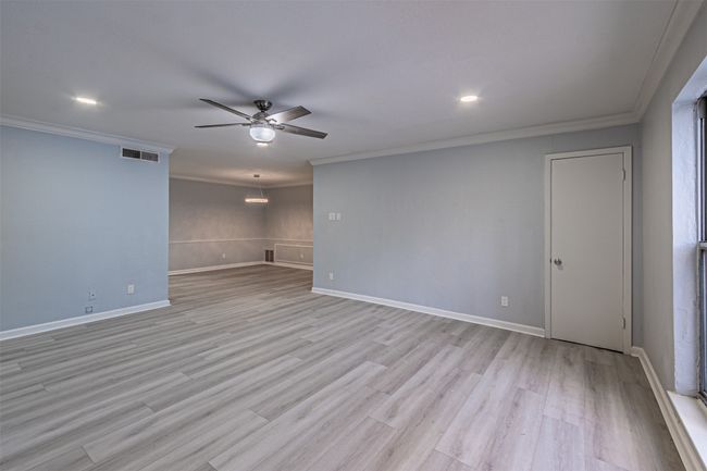 Unfurnished room with ceiling fan, ornamental molding, and light wood-type flooring | Image 34