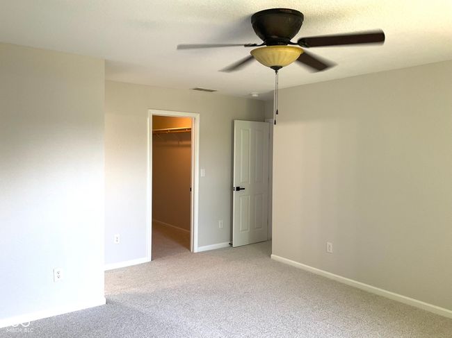 Spacious primary bedroom with new paint and carpeting | Image 21