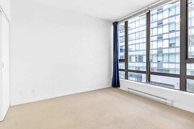 Spare room with a baseboard heating unit and carpet | Image 16