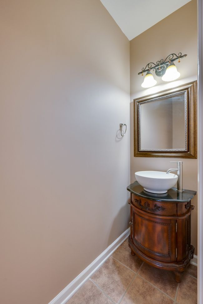 Half bath located in the living room with vessel bathroom sink. | Image 12