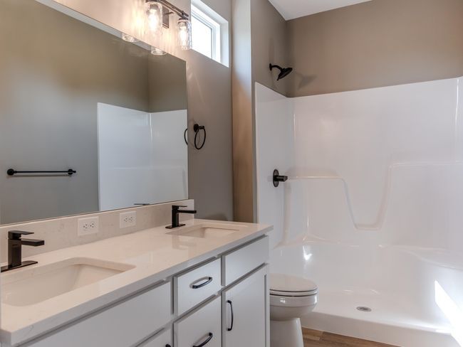 Bathroom with double vanity, walk in shower, wood-type flooring, and toilet | Image 9
