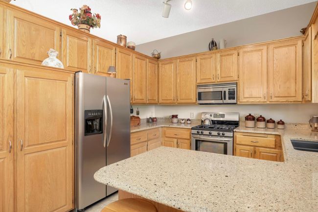 Kitchen with Cambria countertops and stainless-steel appliances. | Image 16