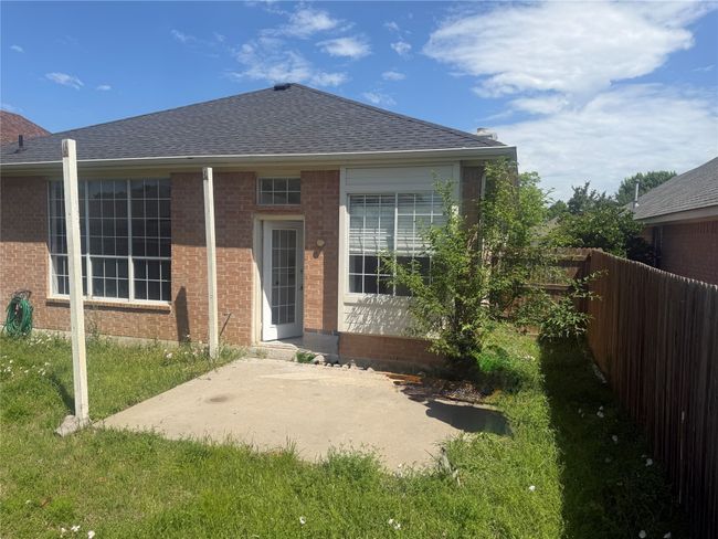 Back of property with fence, brick siding, a patio area, a shingled roof, and a yard | Image 20
