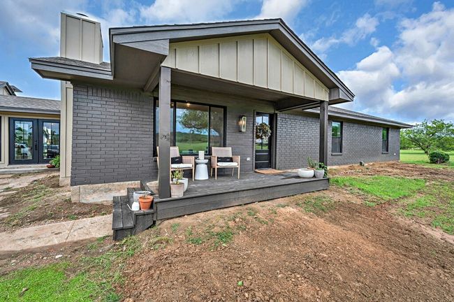 Dining area with french doors, and board and batten siding | Image 4