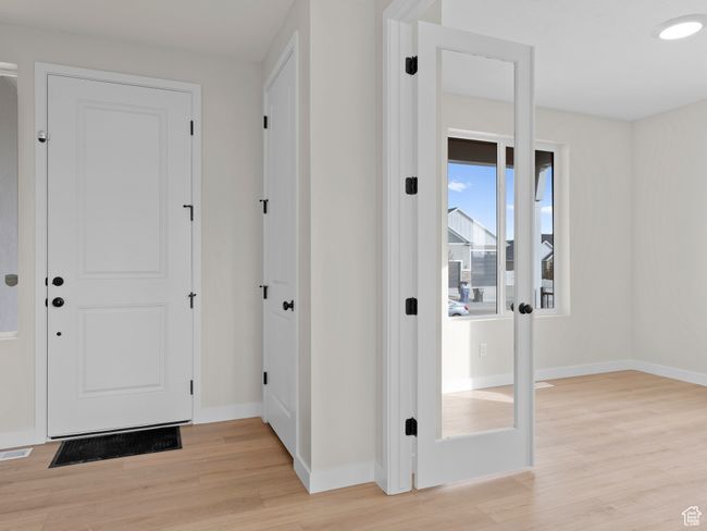 Interior space with baseboards, visible vents, and light wood-style floors | Image 5