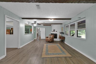 Living room fills with natural light and a view of the large covered porch & backyard. | Image 3