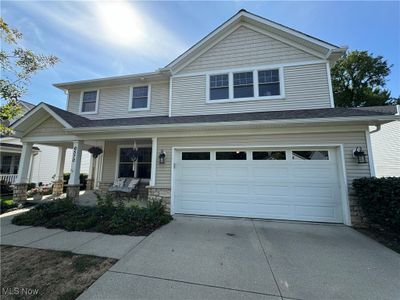 View of front of home with a garage and a porch | Image 1