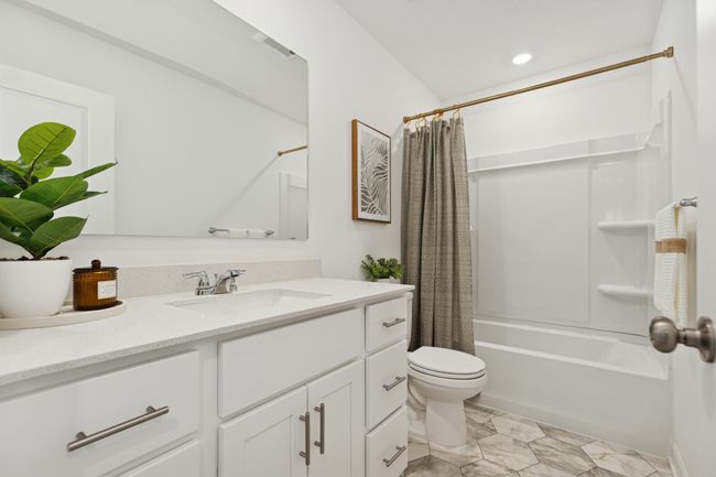 (Photo of model home, features will vary) A full-sized bathroom on the second floor comes well-equipped with a generously sized quartz-topped vanity and a combination shower and tub to maximize the interior space. | Image 15