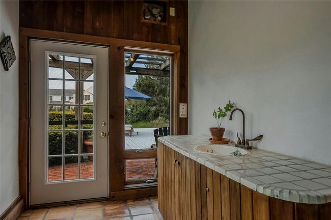 Doorway to outside with a sink | Image 13