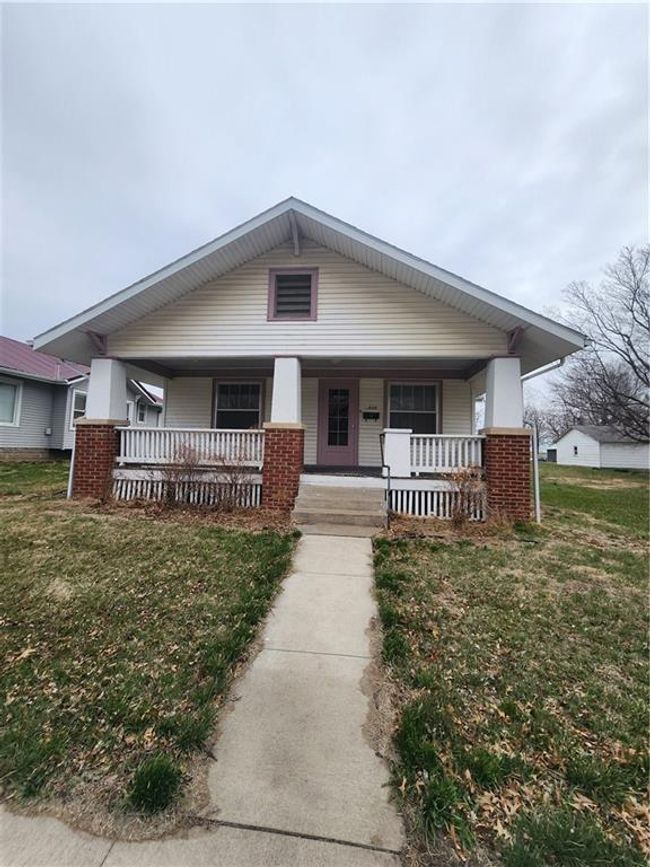 Bungalow-style home with a front lawn, a porch, and brick siding | Image 4