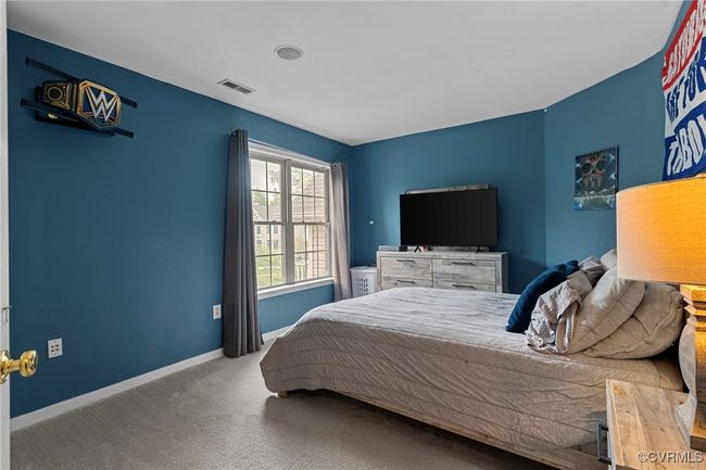 Carpeted bedroom with visible vents and baseboards | Image 38