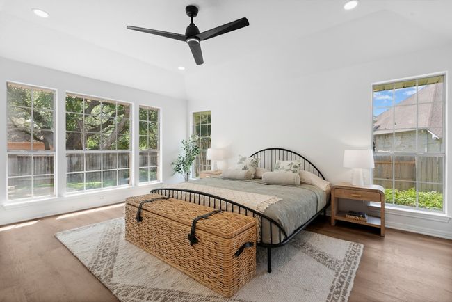 Tucked at the back of the home, the primary bedroom offers privacy and tranquility—plus an abundance of windows that fill the space with natural light | Image 4