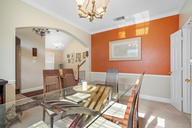 Dining space with a chandelier, arched walkways, ornamental molding, and vaulted ceiling | Image 11