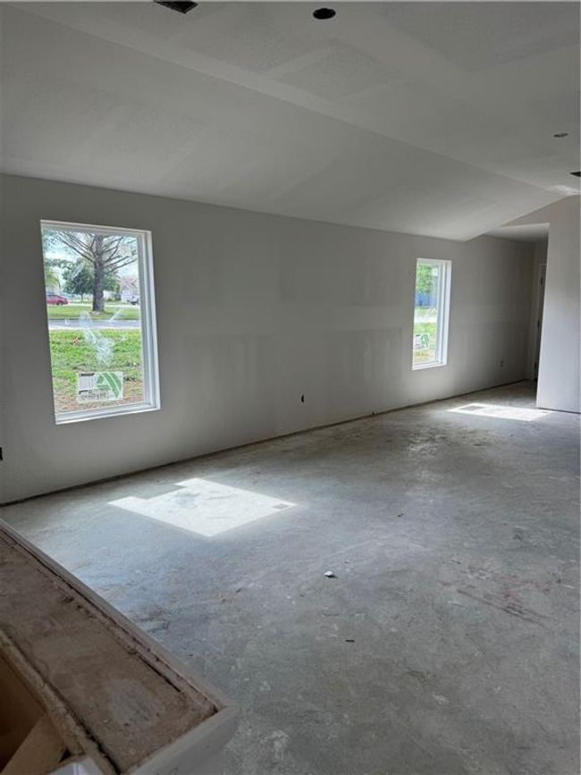 Empty room with concrete floors and vaulted ceiling | Image 4