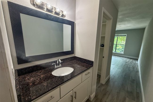 Bathroom featuring vanity, wood finished floors, and a textured wall | Image 25