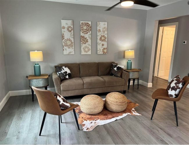 Living area featuring baseboards, wood finished floors, and a ceiling fan | Image 6