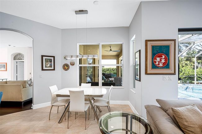 Eating space in kitchen overlooking pool lanai and natural Florida backdrop! | Image 12