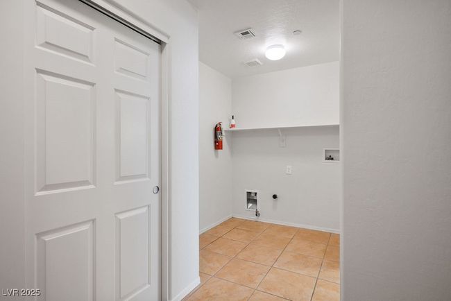 Spacious laundry room with added storage closet. Entrance from garage. | Image 14