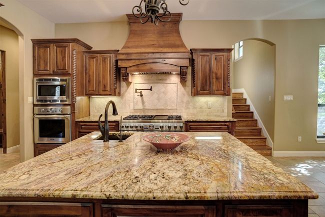 Kitchen boasts high end appliances with 48" Thermador duel fuel range with gas cooktop and griddle. Range has two electric ovens. There is an additional built-in wall Thermador oven. Two dishwashers. Built-In Microwave. Built-In Refrigerator/Freezer. Ice Maker. Two sinks. Pot filler over range. Gorgeous center island. And the Counter space is endless. | Image 5