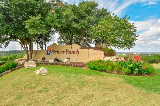 Framed by mature landscaping and limestone accents, the Steiner Ranch entrance makes a quiet statement—welcoming you into one of Austin’s most sought-after hill country communities | Image 32