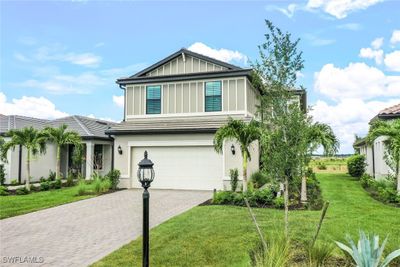 View of front of house with a garage and a front lawn | Image 1