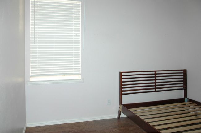 Unfurnished bedroom with wood finished floors and baseboards | Image 10