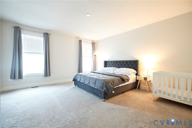 Carpeted bedroom with multiple windows | Image 8