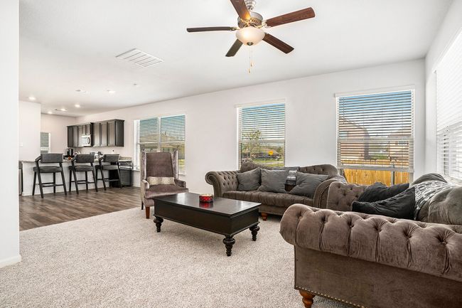 Living area featuring ceiling fan, visible vents, recessed lighting, carpet and luxury vinyl plank floors. | Image 6