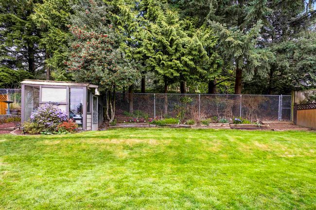 View of yard featuring an outbuilding, a fenced backyard, and a storage unit | Image 32