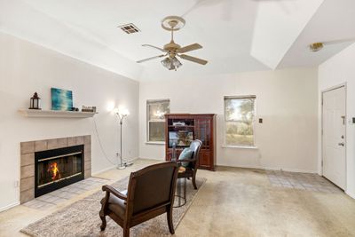 Living room boosts high ceilings and a fireplace | Image 3