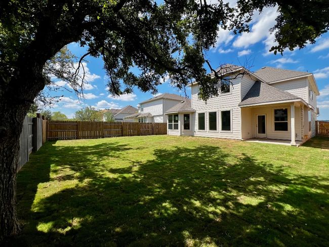 Back of property with roof with shingles, a patio area, and a fenced backyard | Image 21