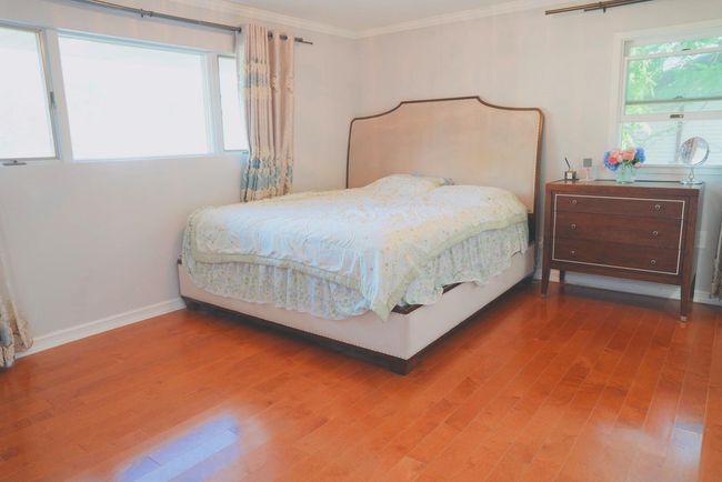 Bedroom featuring wood finished floors and crown molding | Image 8
