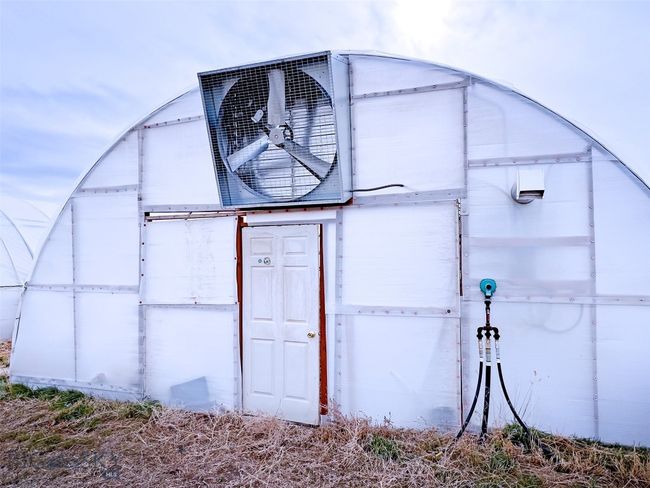 front of one of the 24' 133' green houses | Image 9