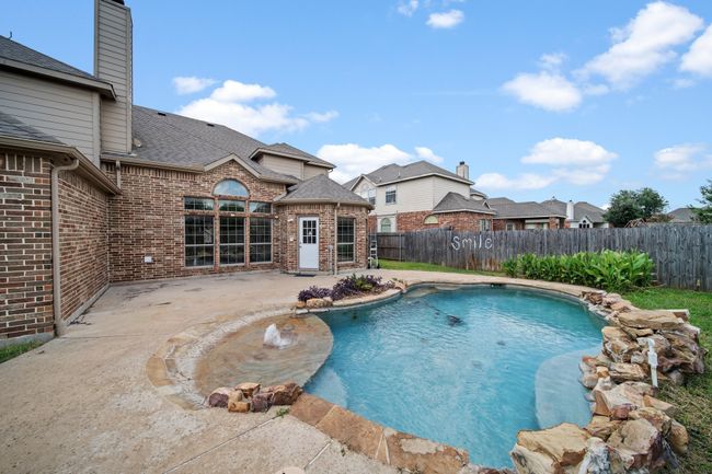 View of pool with a fenced in pool, a fenced backyard, and a patio area | Image 36