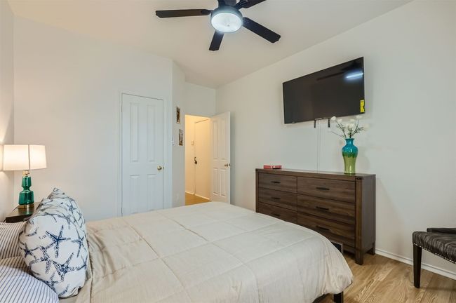 Bedroom with wood finished floors and a ceiling fan | Image 21